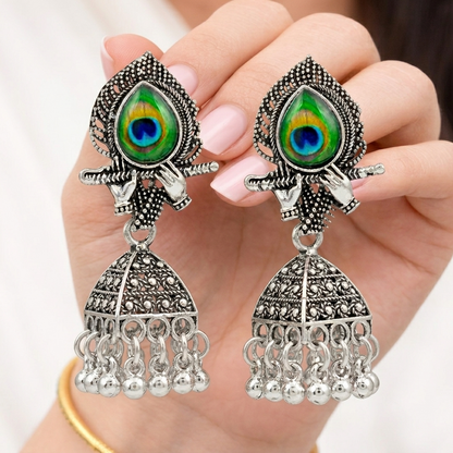 Silver Peacock Feather Jhumka Earrings – Krishna Flute Motif & Filigree Beads
